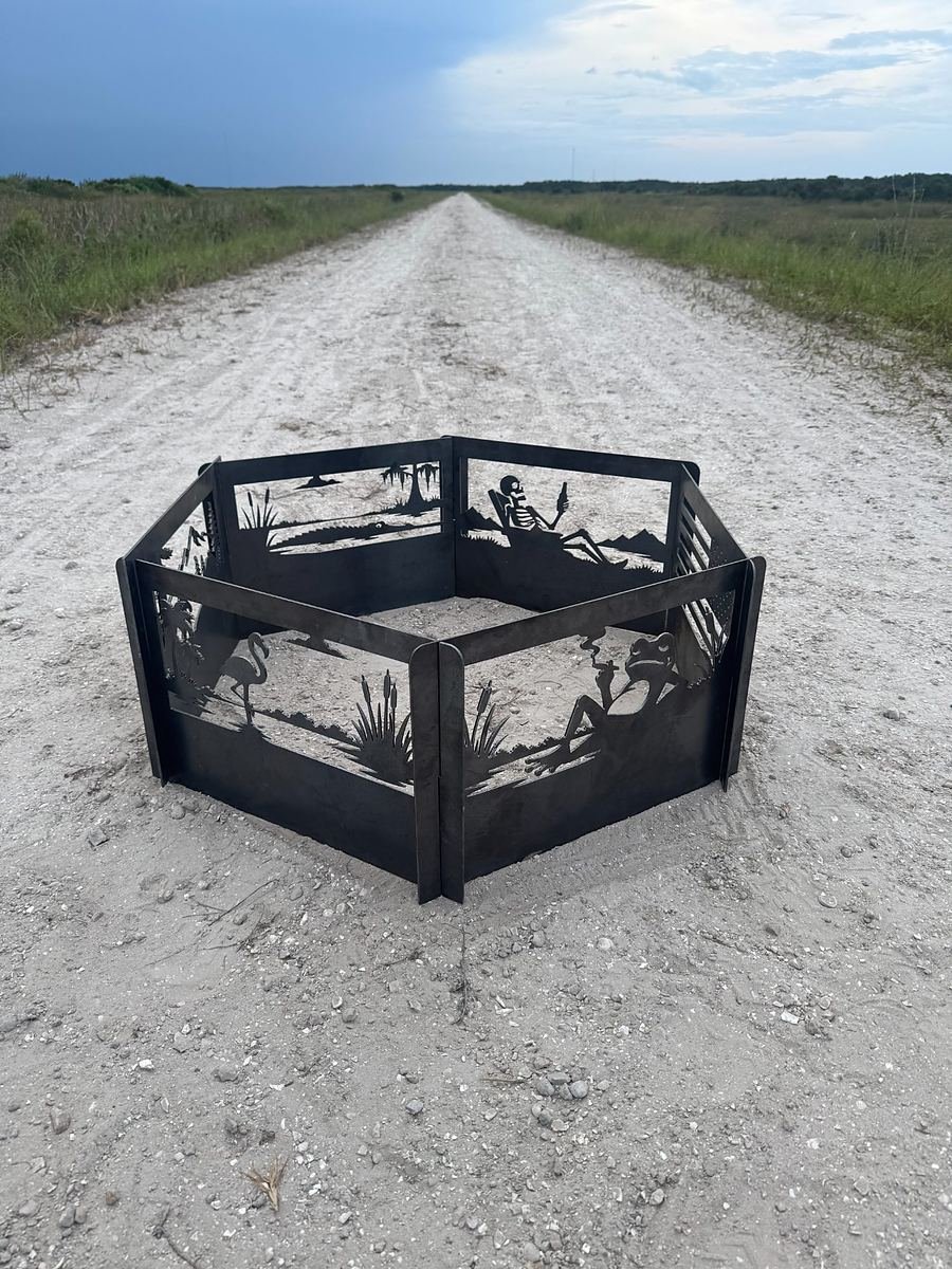 Hand-built steel fire ring with the American flag panel forward, on a limestone road