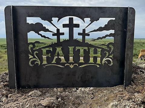 Steel fire pit panel with three crosses on a hill, radiating clouds and the word FAITH in scrollwork