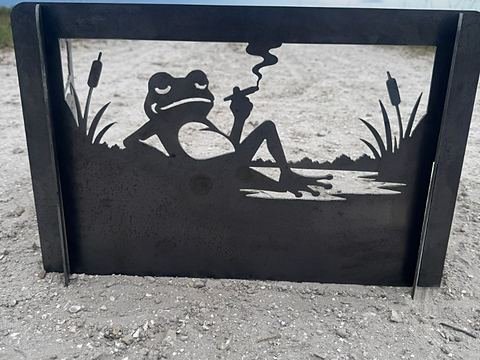 Steel panel cut with a reclining frog smoking a cigar among cattails